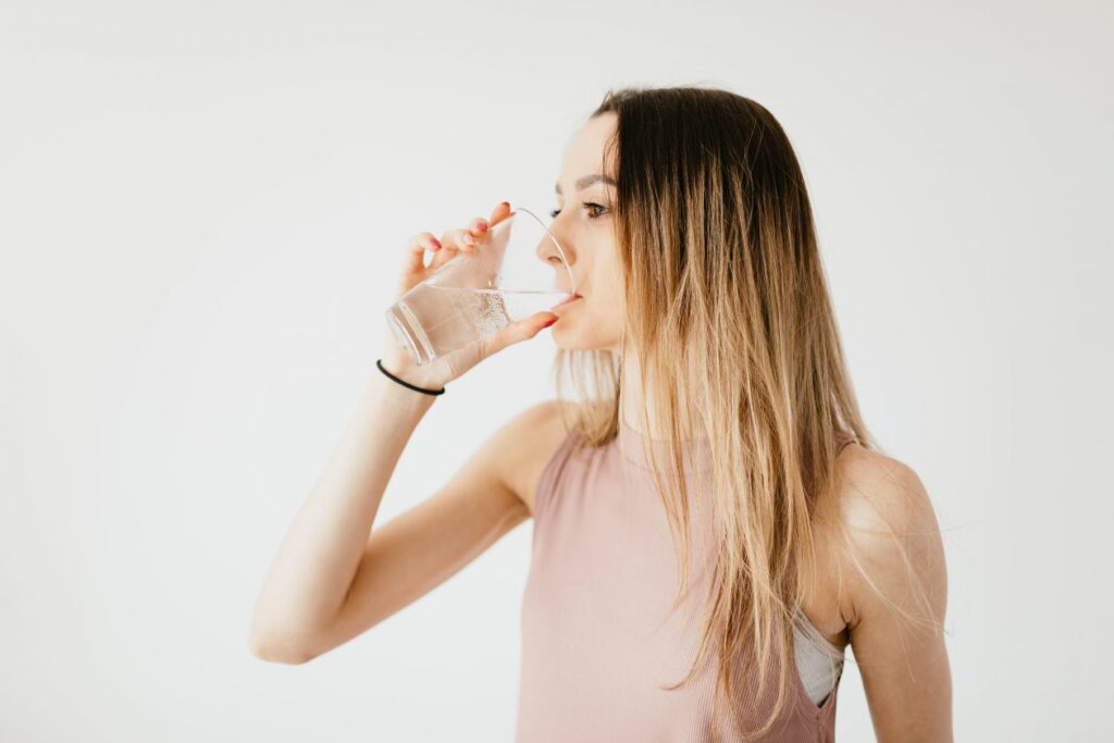 woman-drinking-glass-of-cold-pure-water-