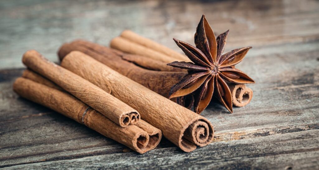 star-anise-cinnamon-sticks-closeup-wooden-background